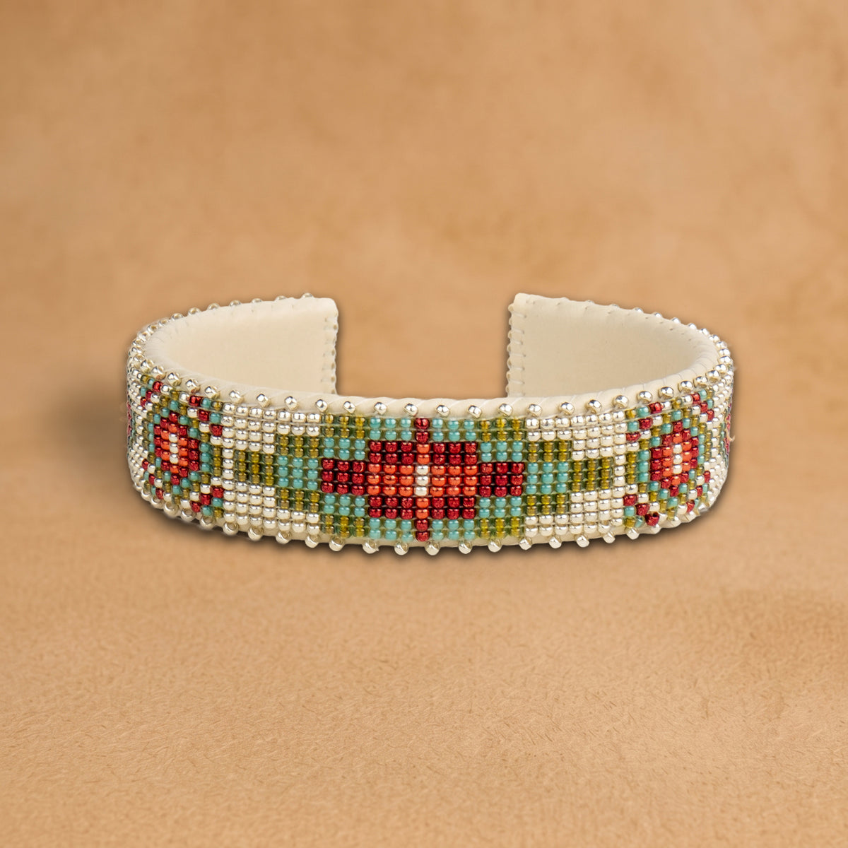 Becca Medium beaded cuff, white beads with a red, turquoise and olive green medallion and red diamonds, handloomed by Navajo artisans in New Mexico