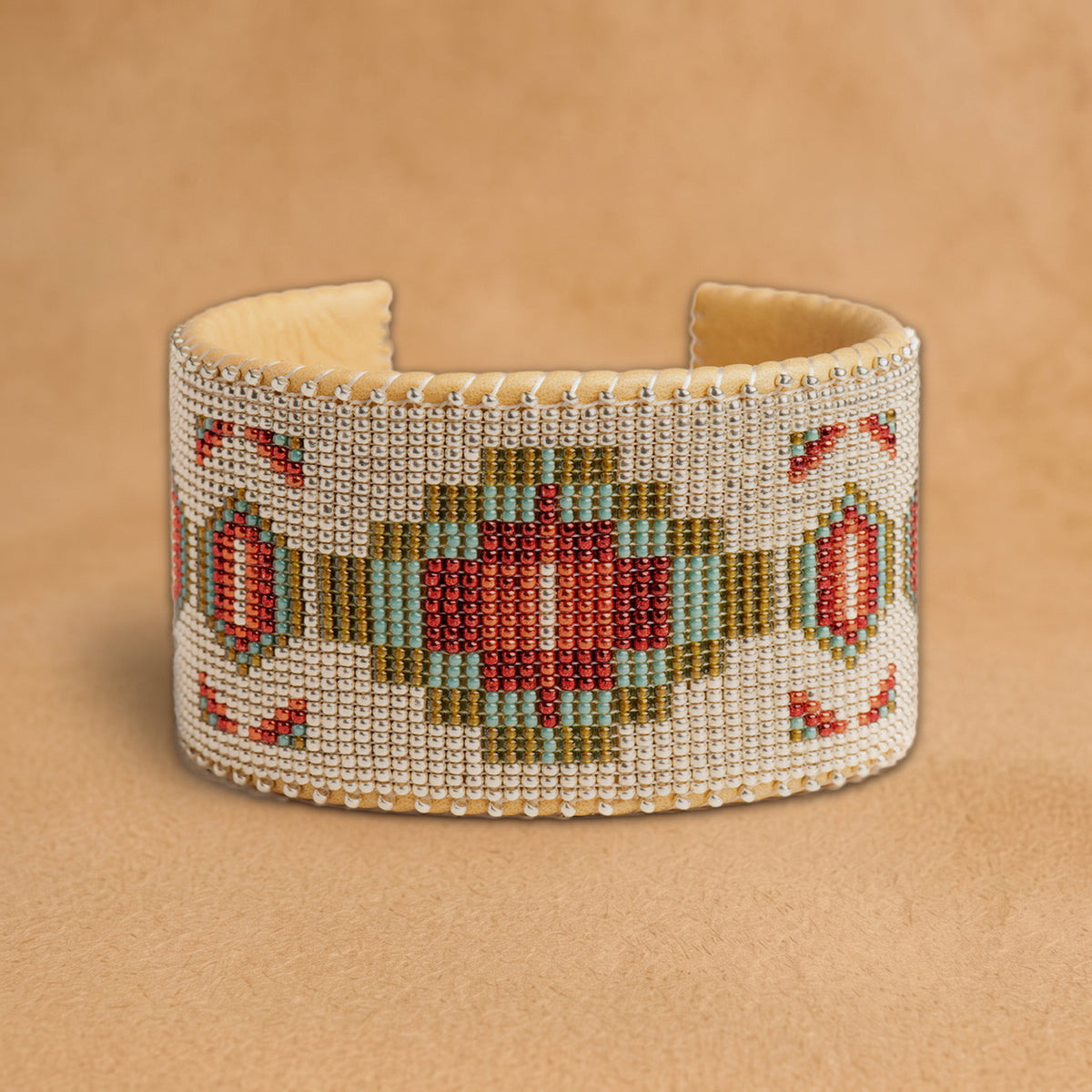 Becca X Large beaded cuff, white beads with a red, turquoise and olive green medallion and red diamonds, handloomed by Navajo artisans in New Mexico