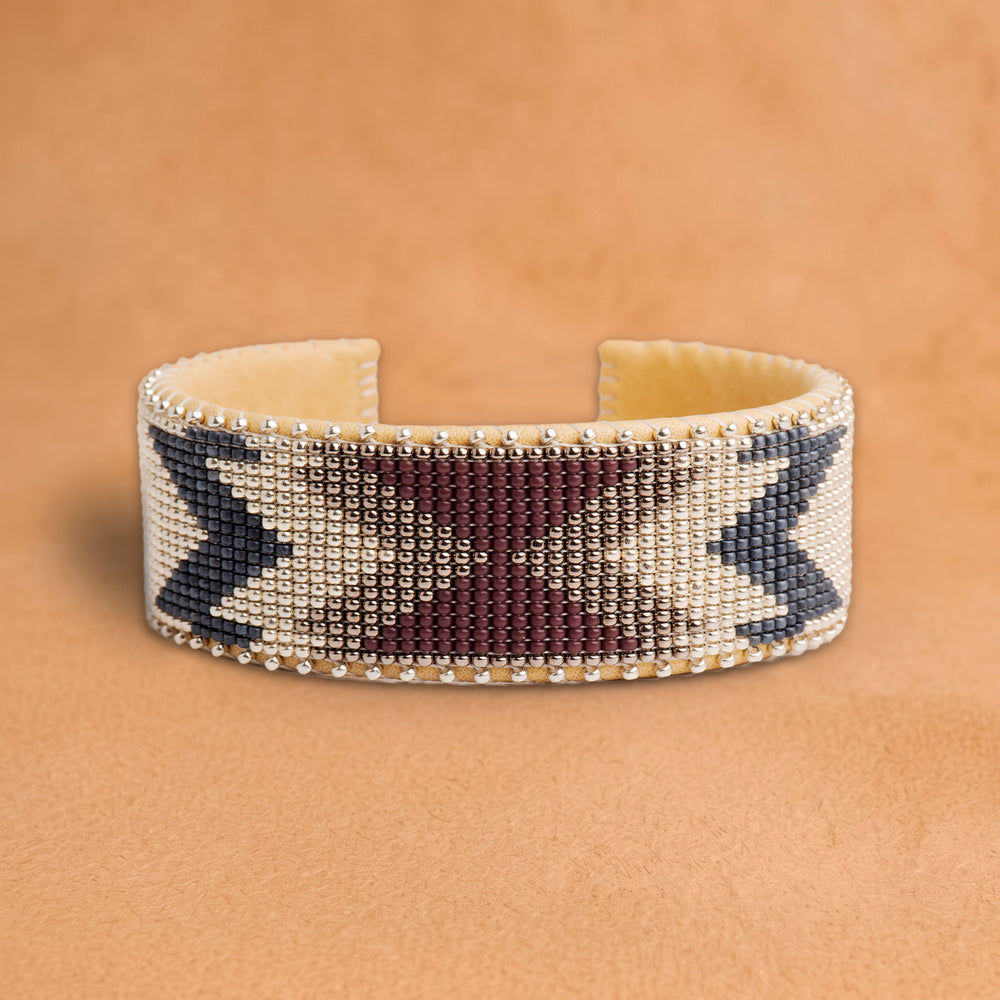 Bramble Large beaded cuff, cream with plum and slate blue arrow shapes, handloomed by Navajo artisans in New Mexico