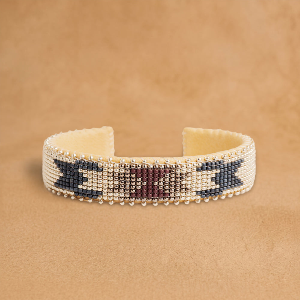 Bramble Small beaded cuff, cream with plum and slate blue arrow shapes, handloomed by Navajo artisans in New Mexico