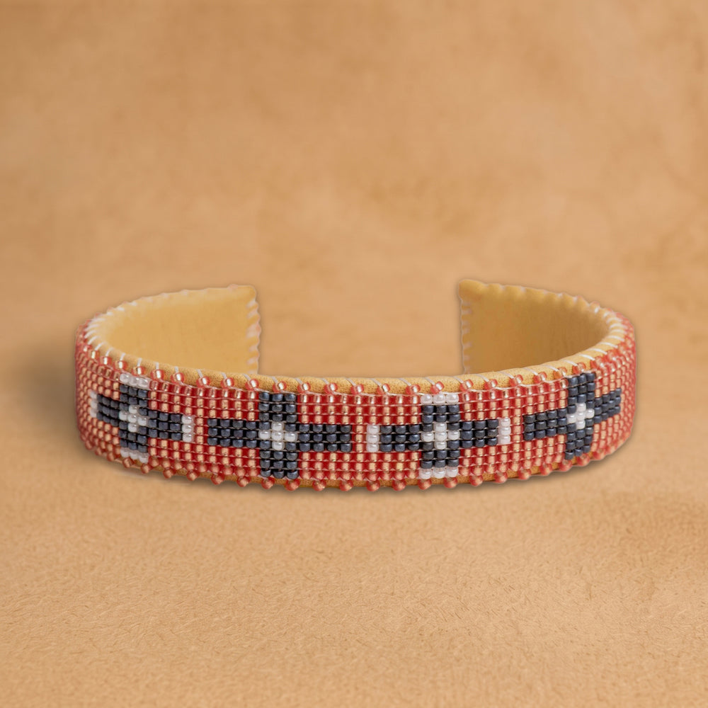 Faith Small beaded cuff, coral with charcoal and white crosses, handloomed by Navajo artisans in New Mexico