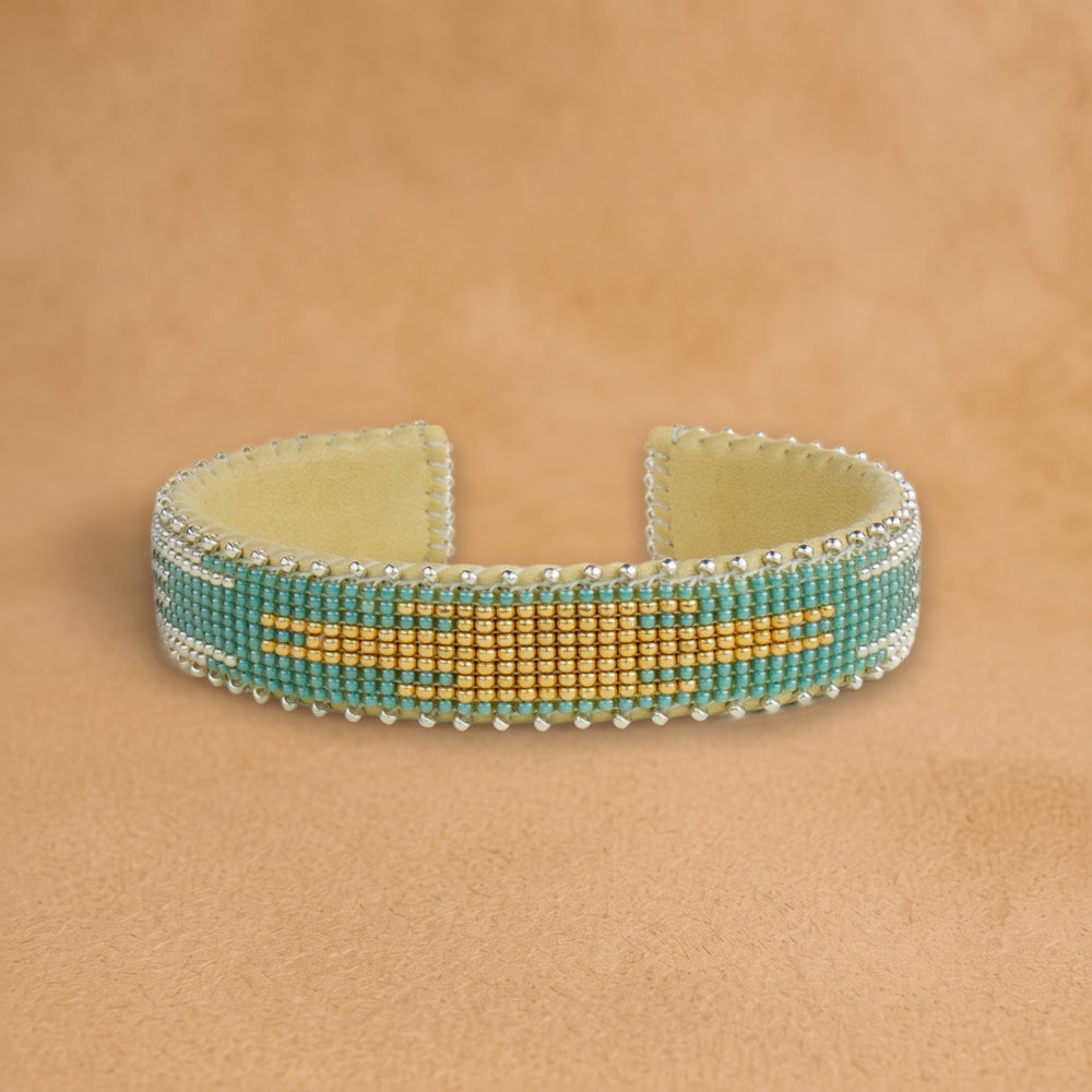 Fiona Small beaded cuff, turquoise with a gold and silver flame center, handloomed by Navajo artisans in New Mexico