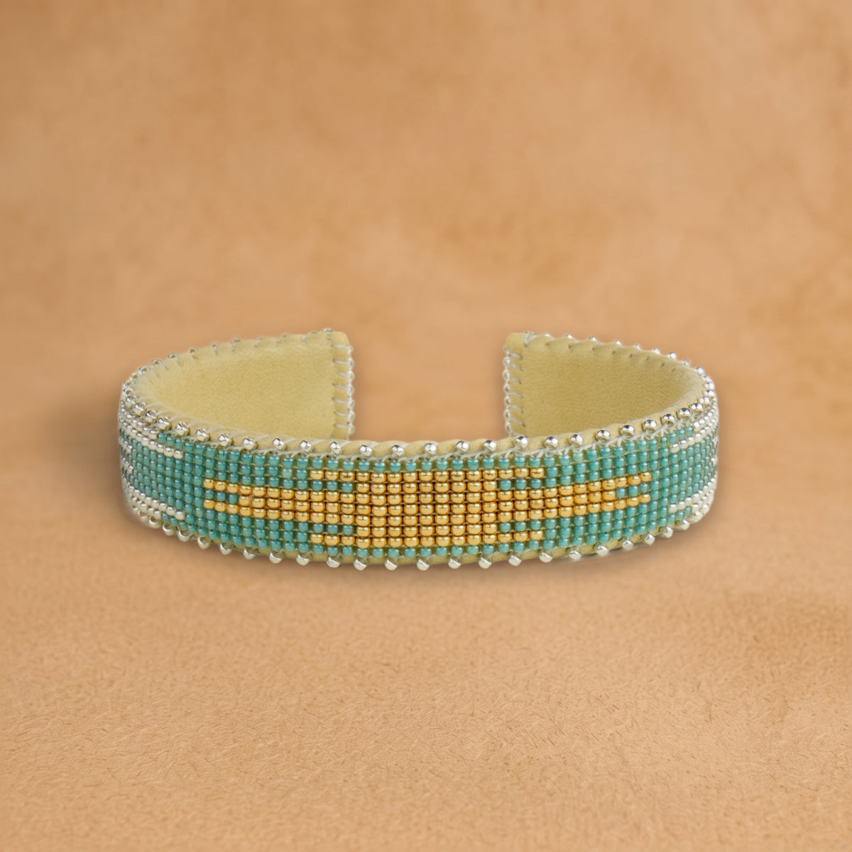 Fiona Small beaded cuff, turquoise with a gold and silver flame center, handloomed by Navajo artisans in New Mexico
