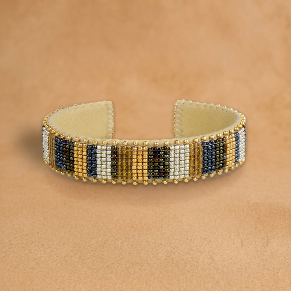 Jordan Small beaded cuff, vertical stripes in gold, navy, cream and black, handloomed by Navajo artisans in New Mexico