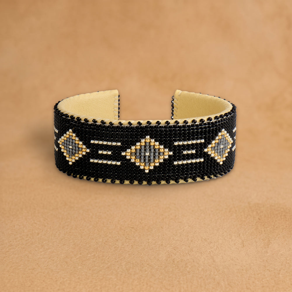 Kelly Large beaded cuff, black with grey diamonds outlined in gold and white dashes, handloomed by Navajo artisans in New Mexico