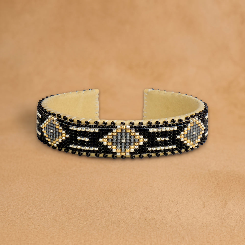 Kelly Small beaded cuff, black with grey diamonds outlined in gold and white dashes, handloomed by Navajo artisans in New Mexico