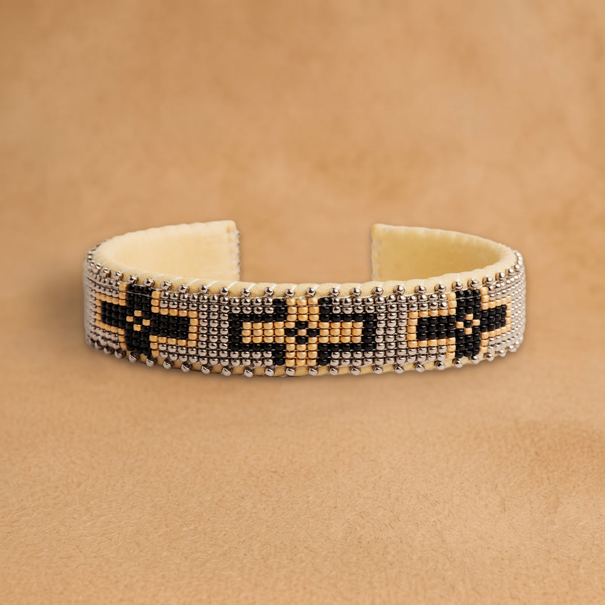 Maize Small 7 inch beaded cuff, silver-grey with black and peach crosses, handloomed by Navajo artisans in New Mexico