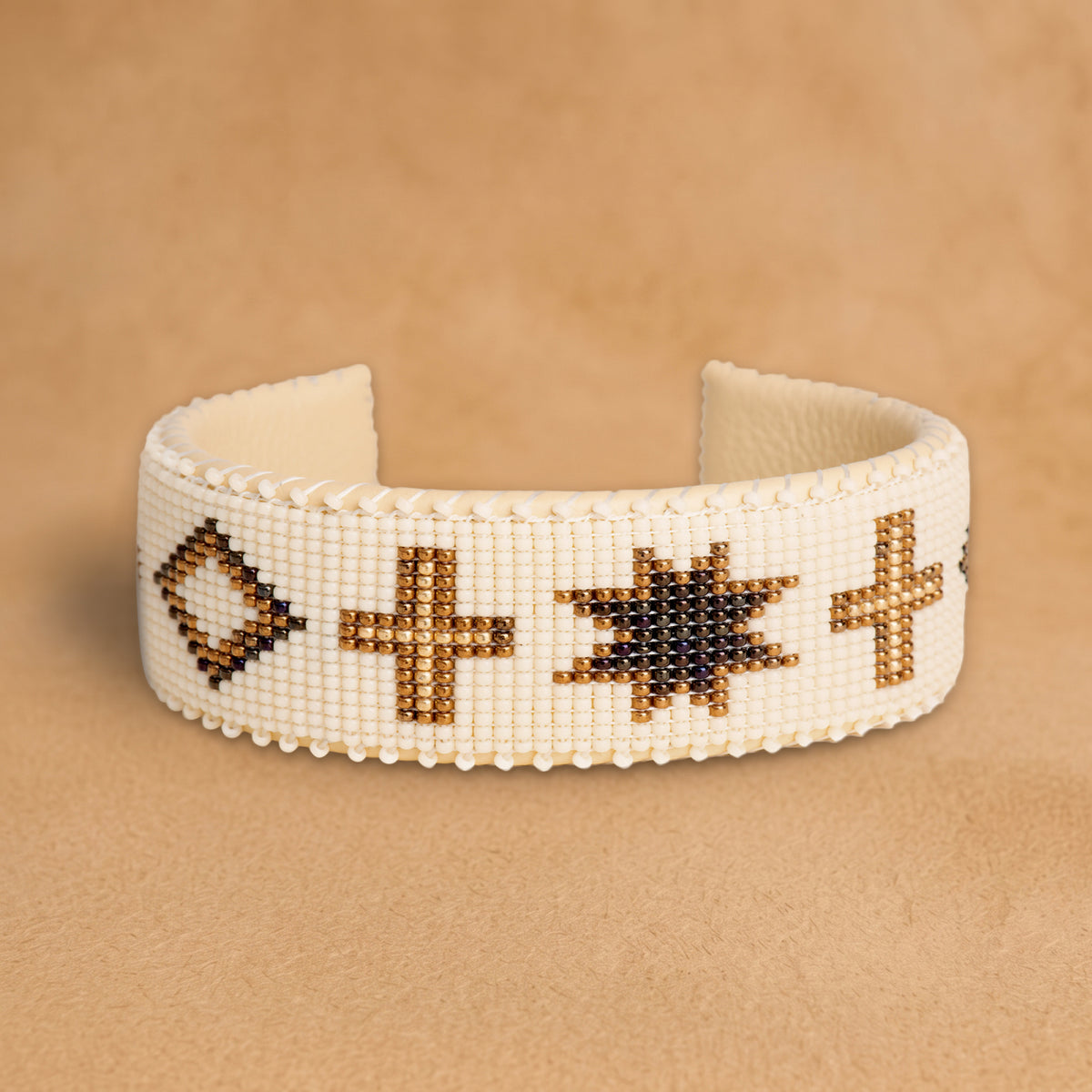 Noelle Large beaded cuff, cream with bronze crosses, diamonds and eight-point stars, handloomed by Navajo artisans in New Mexico
