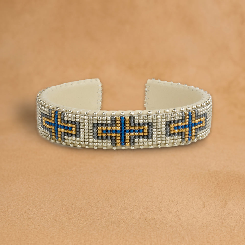 Nora Small beaded cuff, silver with cobalt blue and gold crosses, handloomed by Navajo artisans in New Mexico
