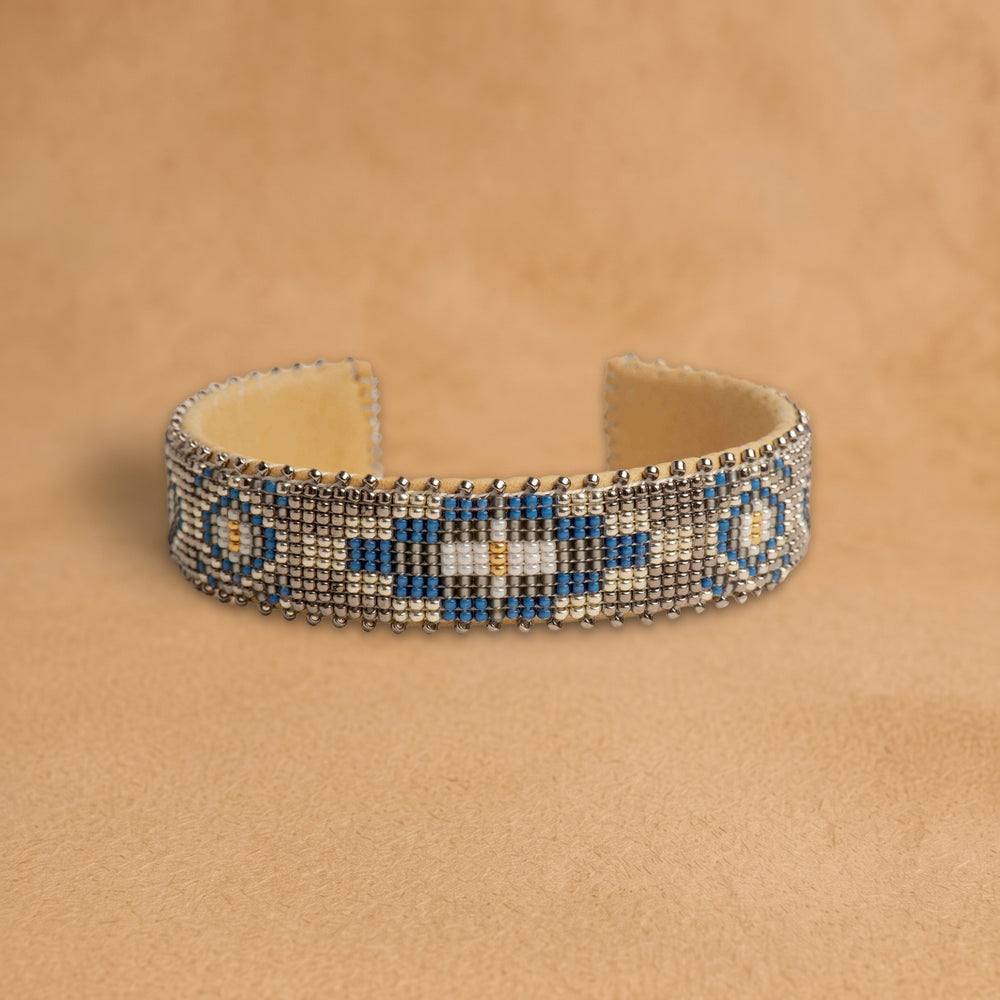 Paloma Medium beaded cuff, taupe with a cobalt blue, black and cream medallion, handloomed by Navajo artisans in New Mexico