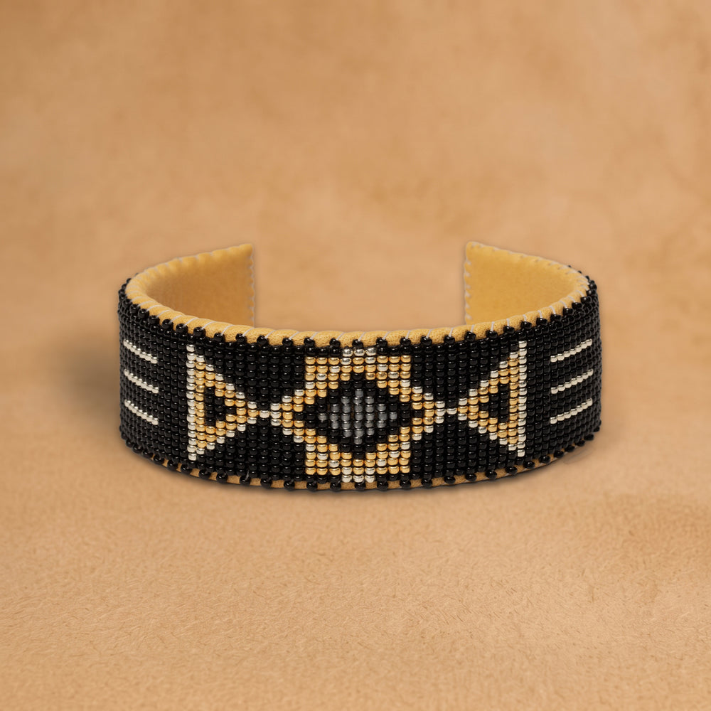 Raven Large 7 Inch beaded cuff, black with gold triangles and a grey diamond, handloomed by Navajo artisans in New Mexico