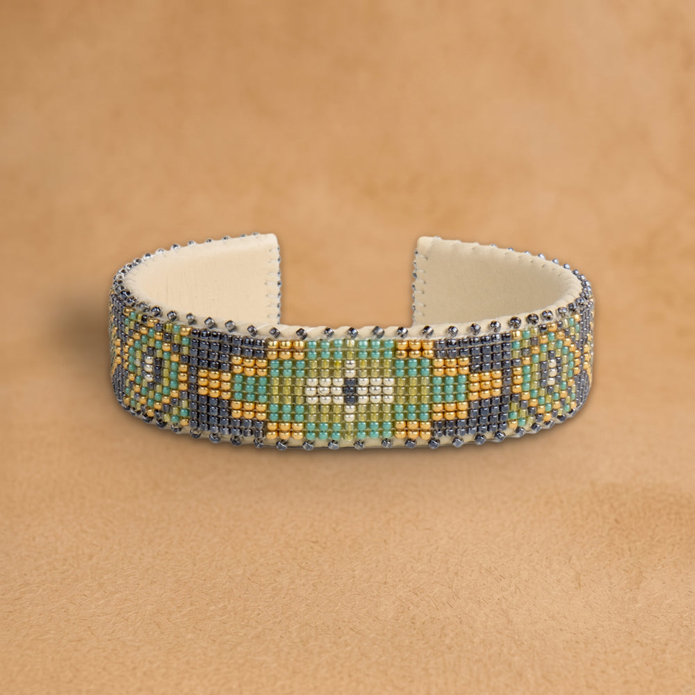 Tai Medium beaded cuff, slate grey with a gold, sage and mint medallion, handloomed by Navajo artisans in New Mexico