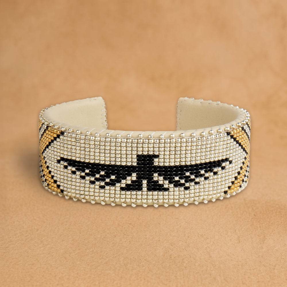 Tallulah Large beaded cuff, silver with a black thunderbird and gold chevrons, handloomed by Navajo artisans in New Mexico