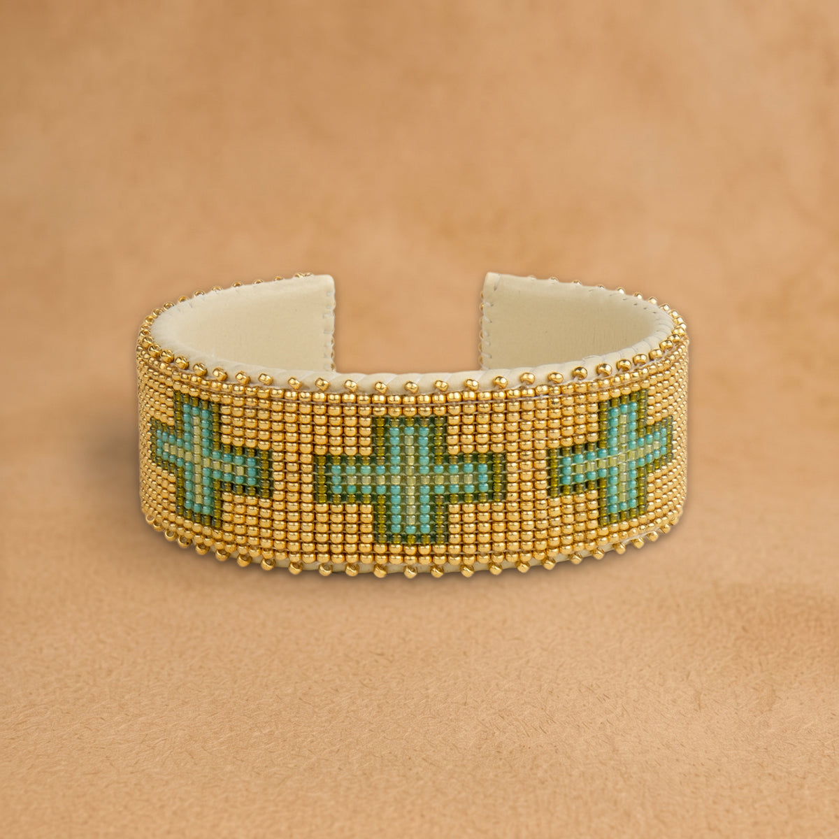 Torian Large beaded cuff, gold with turquoise and green crosses, handloomed by Navajo artisans in New Mexico